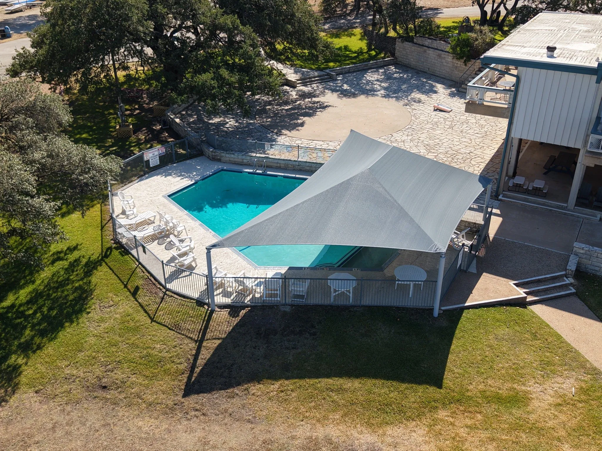 Aerial view of the shade structure covering the poolside seating next to the clubhouse
