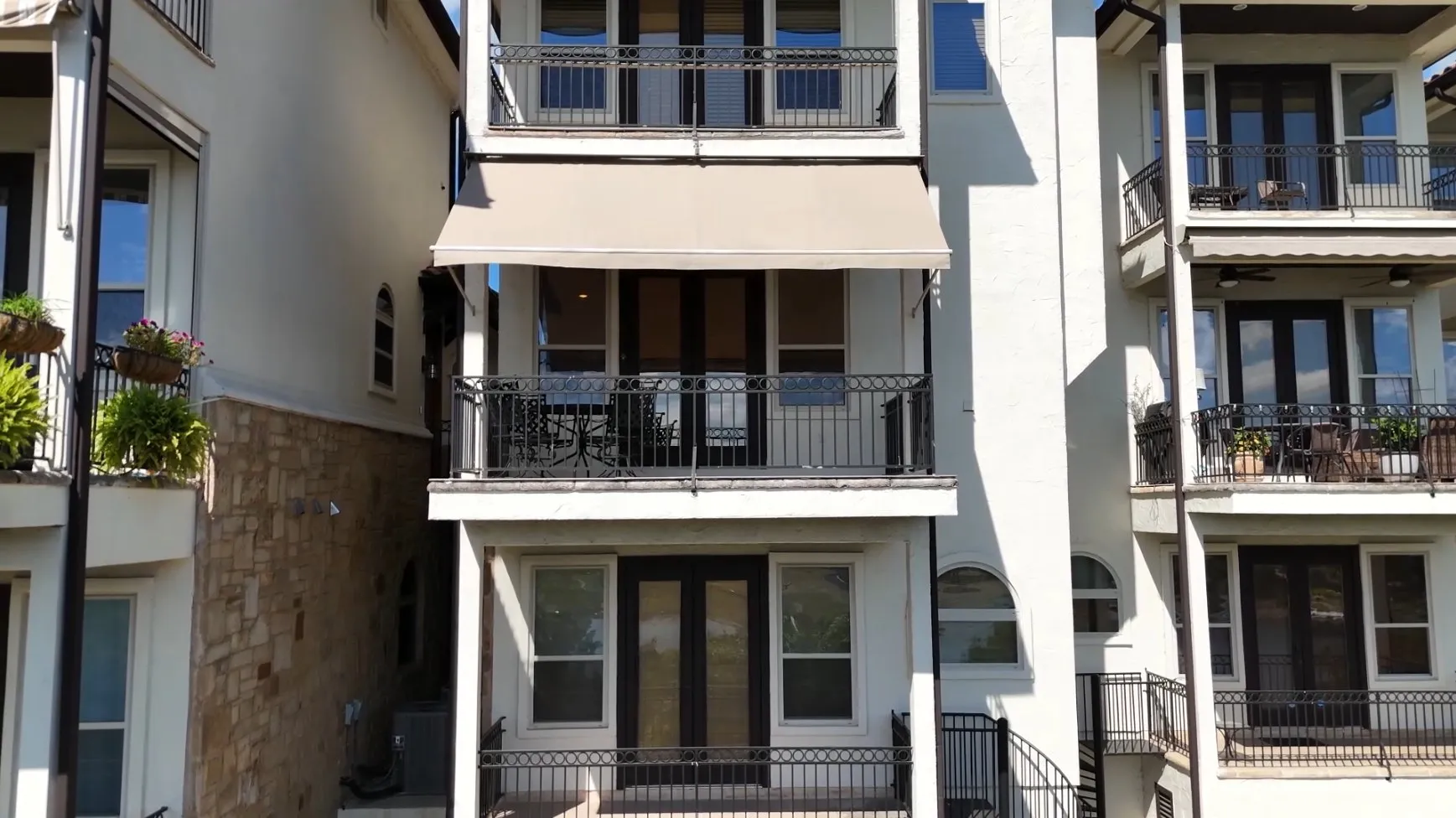 Closer view of the motorized awning shading the condo balcony