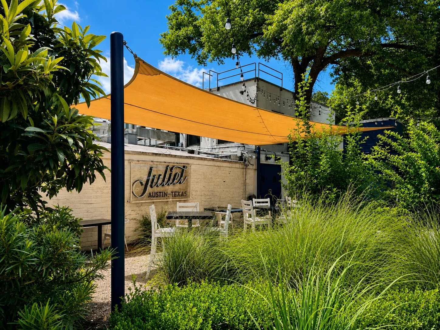 Yellow shade sail over the Juliet Italian Kitchen patio on Barton Springs Road