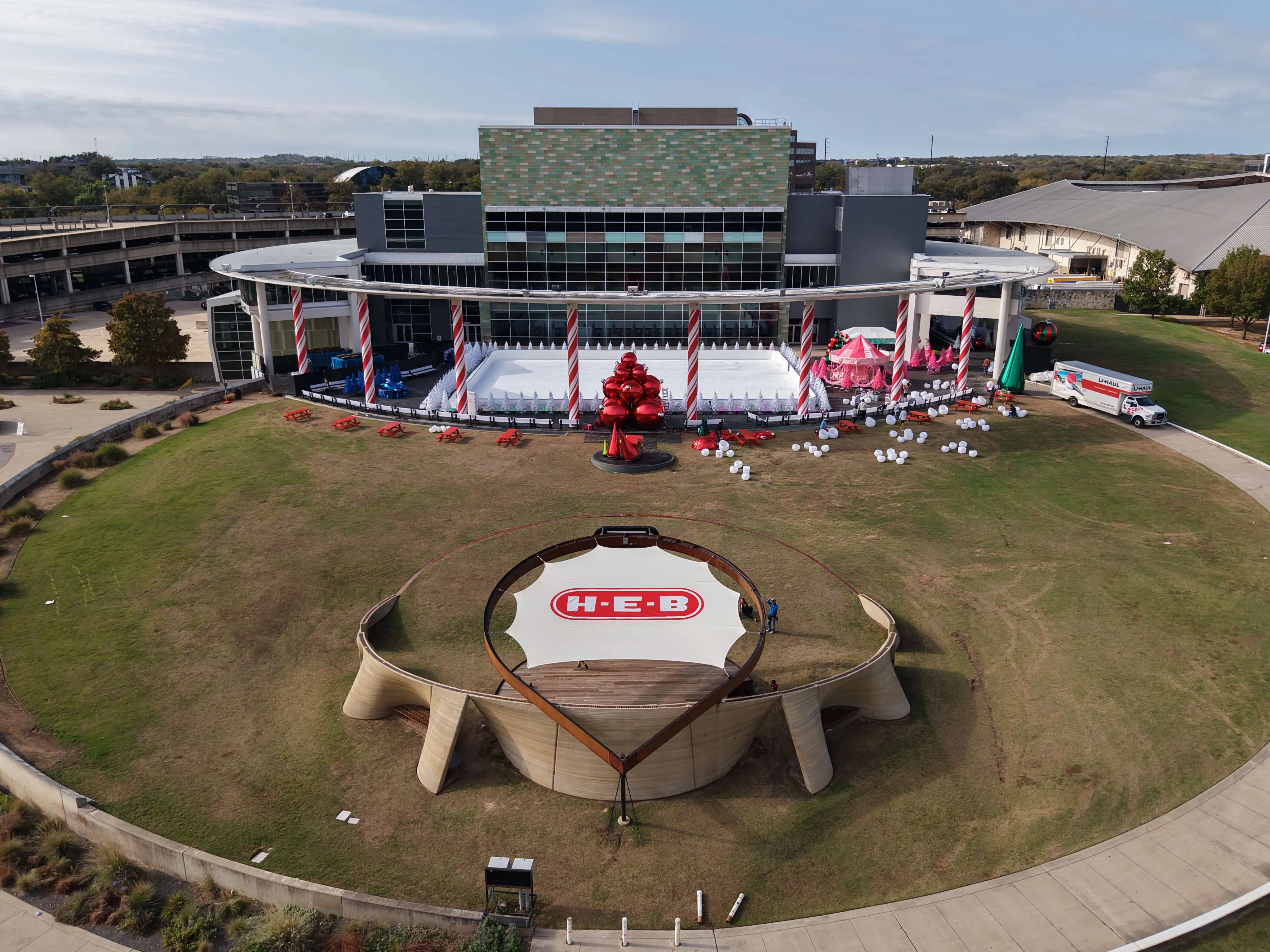 Drone view of the H-E-B logo in the canopy fabric, with The Long Center behind