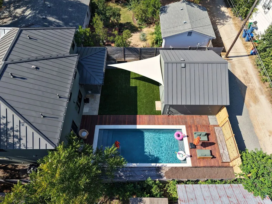 Drone view of the natural triangle sail over a turf yard beside the pool