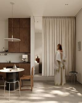Minimalist interior showing a small dining area with round table, two chairs, and wooden cabinets on the left, and a woman in a white dress standing near a cream curtain partially covering a doorway on the right, with soft natural light casting shadows on the floor.