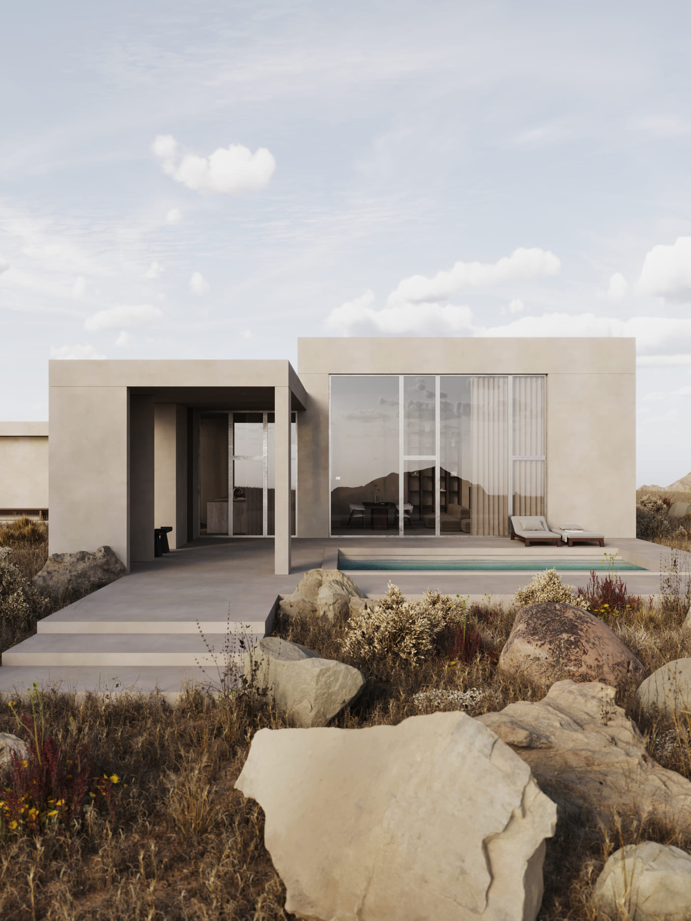 Modern beige single-story house with large floor-to-ceiling windows, a small outdoor pool, and two lounge chairs, surrounded by rocky, dry grass landscape under a partly cloudy sky.