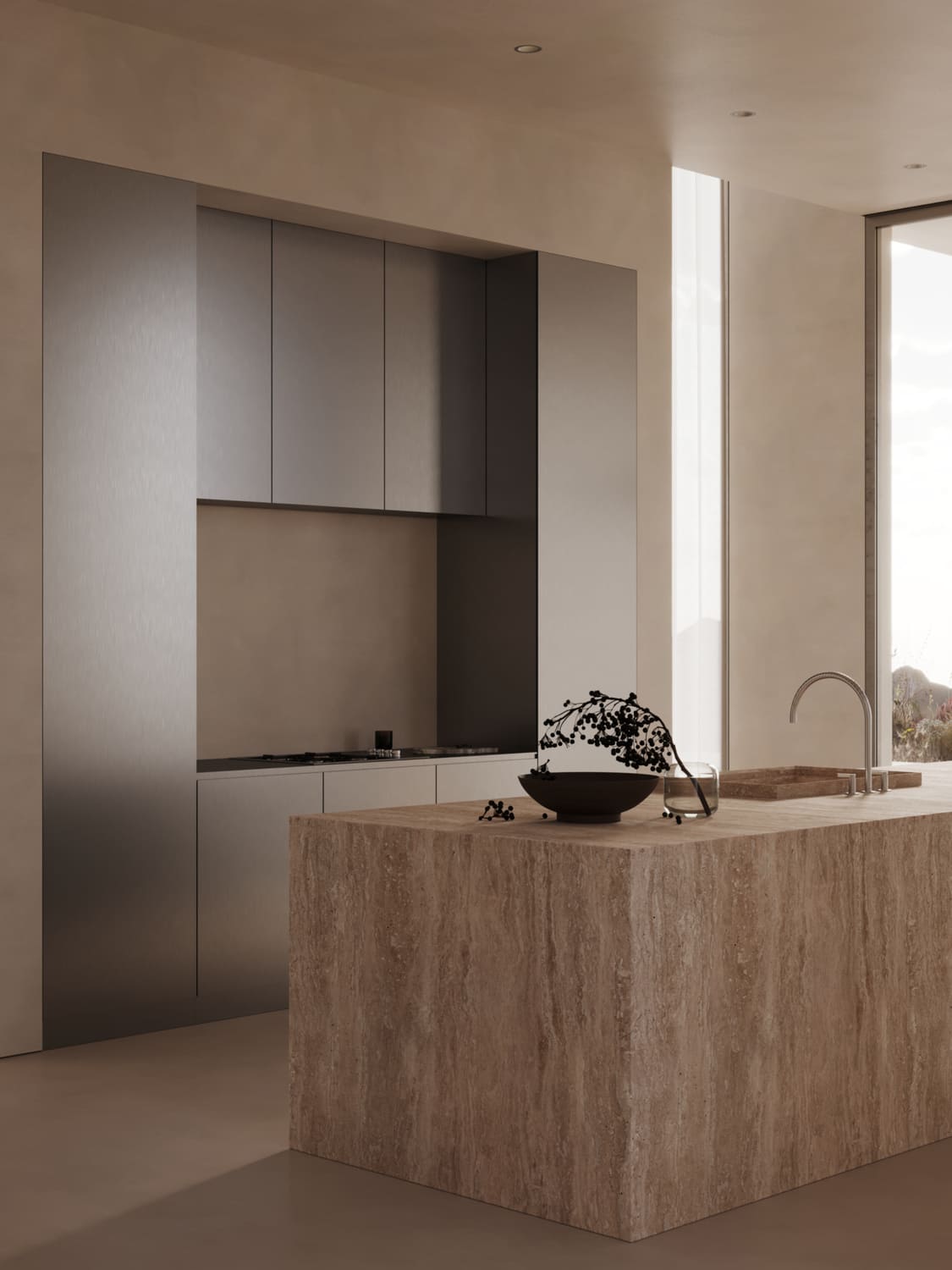 Minimalist kitchen with a large beige stone island featuring an integrated sink with a curved faucet, a dark bowl with berries, and a clear glass, set against taupe walls and sleek gray cabinetry that encloses a stovetop, with natural light coming through a tall, narrow window.