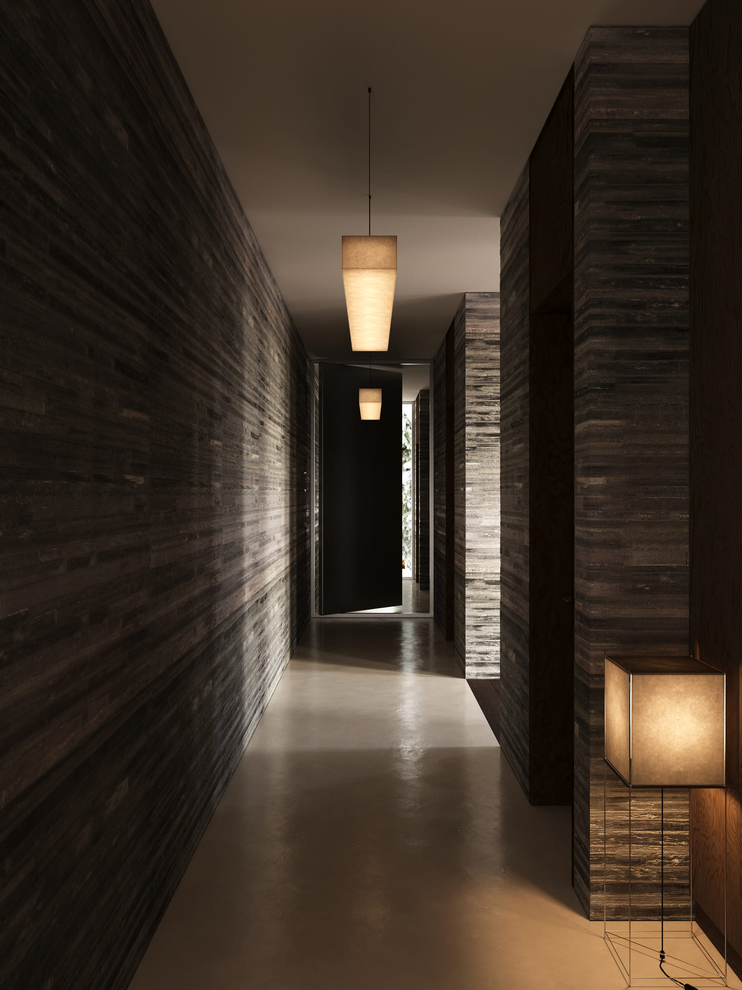 Dimly lit modern hallway with textured dark walls, polished floor, a cube-shaped floor lamp with a wireframe base on the right, and two rectangular pendant lights hanging from the ceiling, leading to a door slightly ajar revealing an outdoor area.