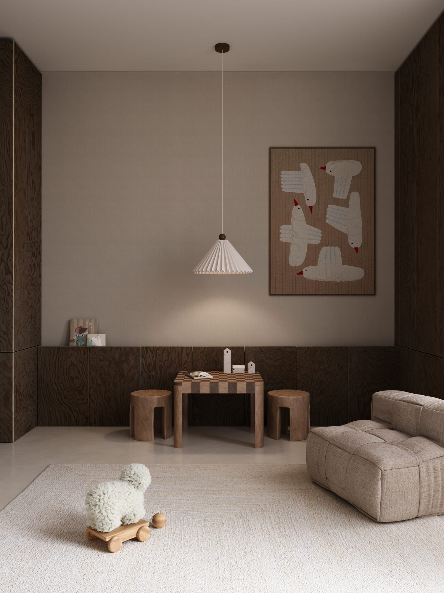 Minimalist children's room with beige walls and dark wood paneling on the lower half, featuring a small checkered wooden table with two matching stools, a hanging white pleated lamp, framed bird artwork on the wall, a beige cushioned chair, and a fluffy white dog toy on wooden wheels placed on a light textured rug.