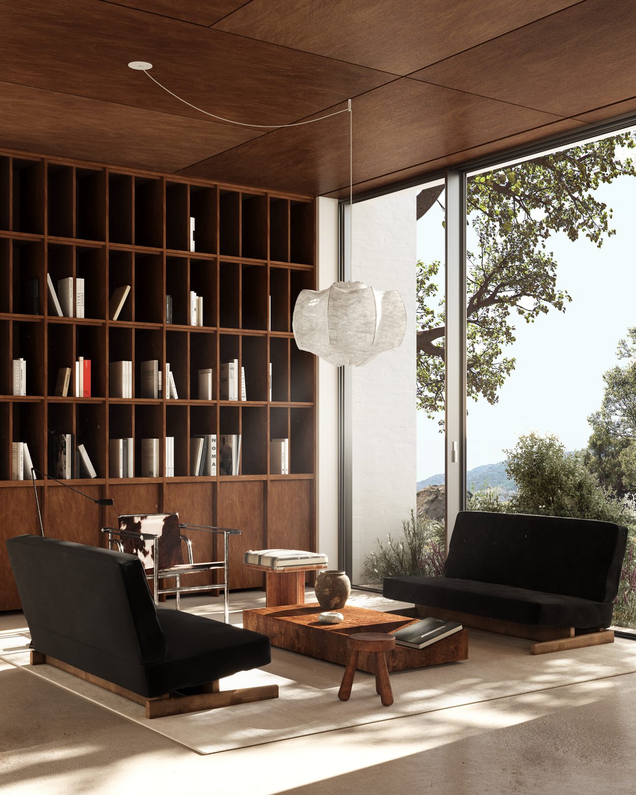 Long minimalist black bench against a softly lit panel wall reflected on a polished floor.