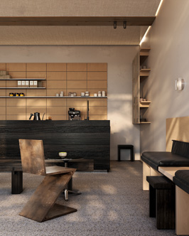 Modern coffee shop interior with a wooden zigzag chair in the foreground, black cushioned bench seating along the wall, wood-paneled shelves, and a black counter with coffee equipment.