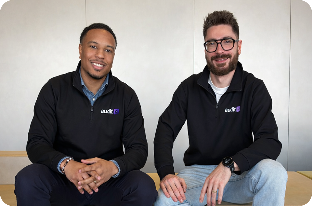Two AuditQ team members seated together