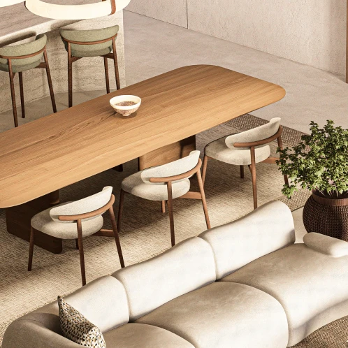 Modern kitchen with concrete island, dark green walls, wooden chairs, and warm lighting.