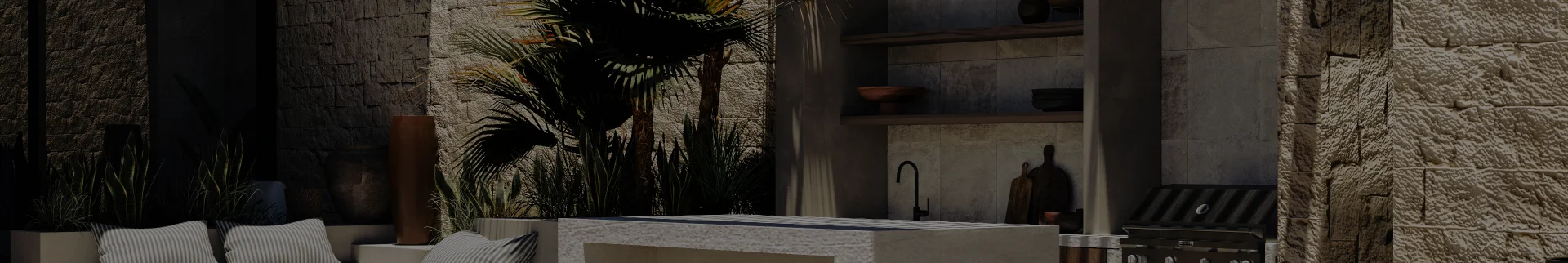 Modern outdoor kitchen area with stone walls, built-in grill, sink, countertop, and potted plants.