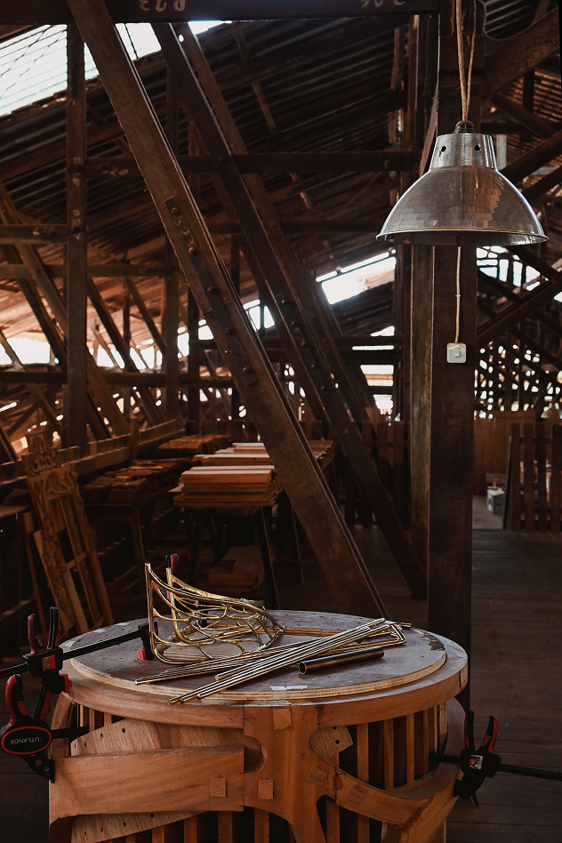 Workshop interior with rafters and tools.