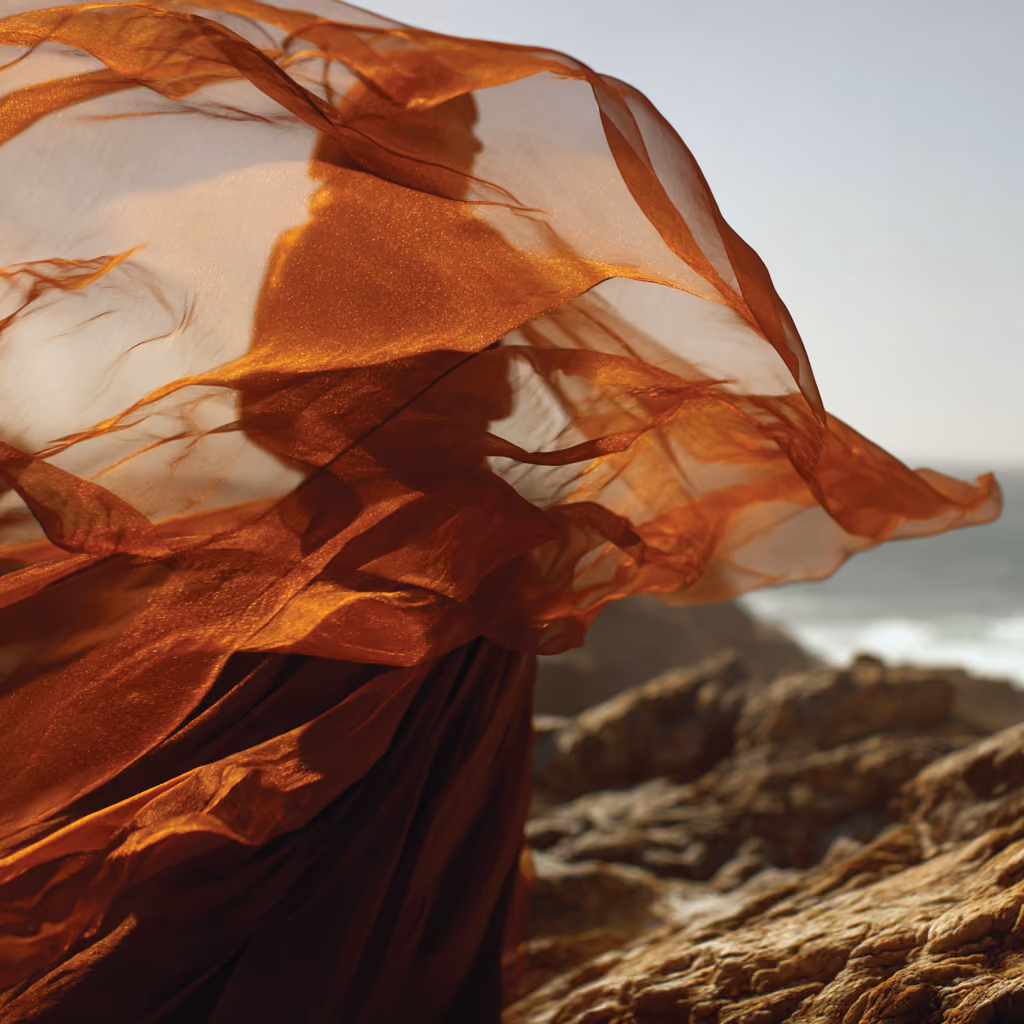Red Desert campaign editorial photo, fabric in motion by the sea.