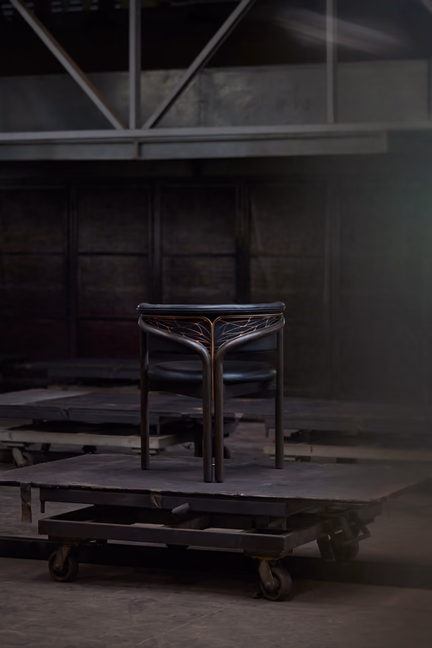 Chair frame on a cart in the workshop.