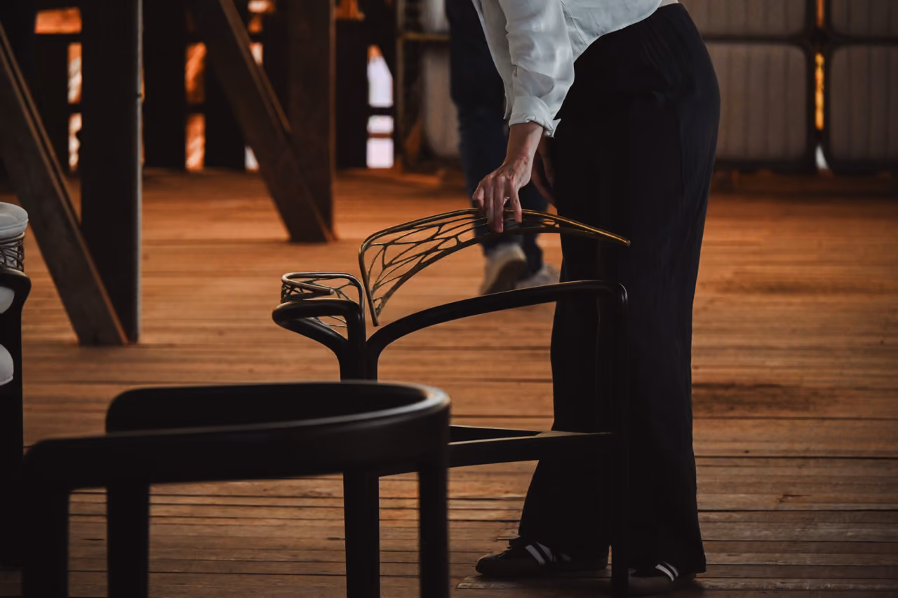 Craftsman assembling a chair frame in the workshop.