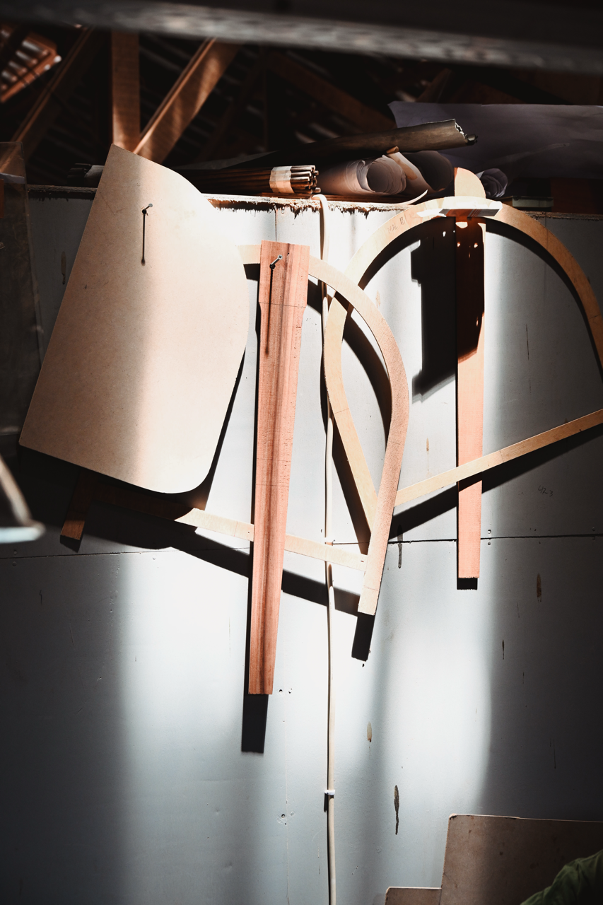 Wood chair components hanging in the workshop.