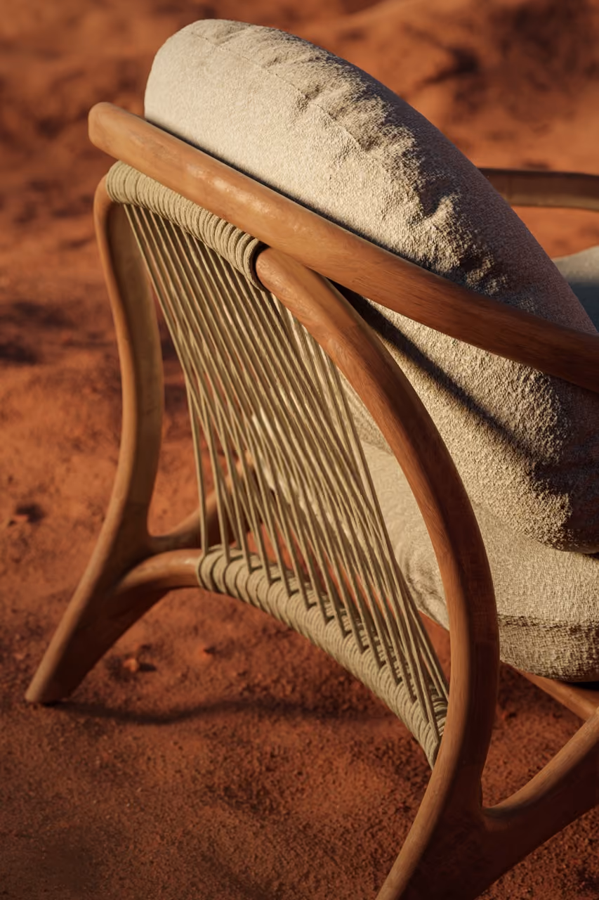 Vime lounge chair, rear view, on desert sand.