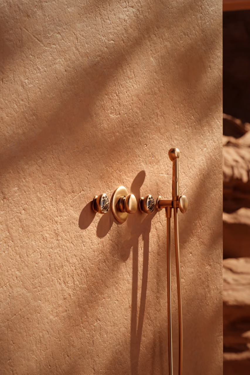 Mirari faucet close-up on a stone counter, desert backdrop.