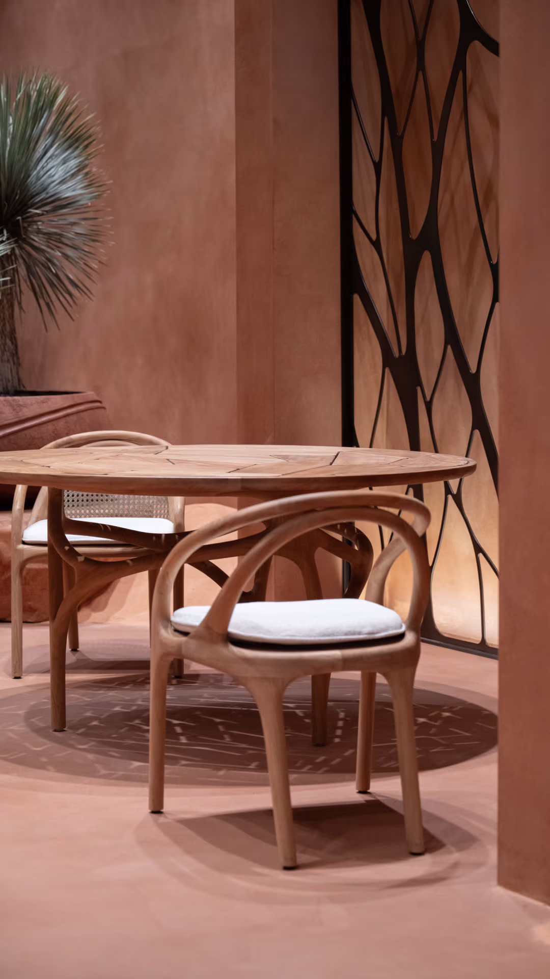 Cena outdoor dining table and Eivissa chairs under an archway.