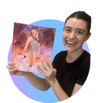Woman smiling holding a Taylor Swift album