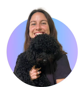 Lady smiling holding dog in her hand