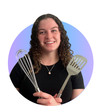 Woman with cooking spoons smiling