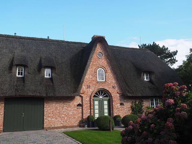 Historisches Friesenhaus mit Reetdach und Backsteinfassade