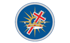Circular emblem with a red and white cross over a gold crown and starburst on a blue background.