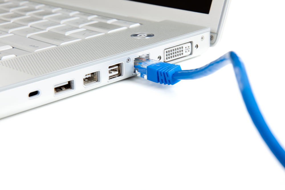 Photo of ethernet cable plugging in to laptop