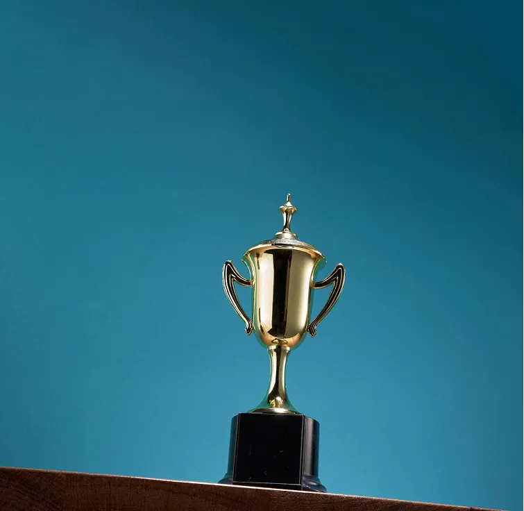Golden trophy cup on a black base against a blue background.