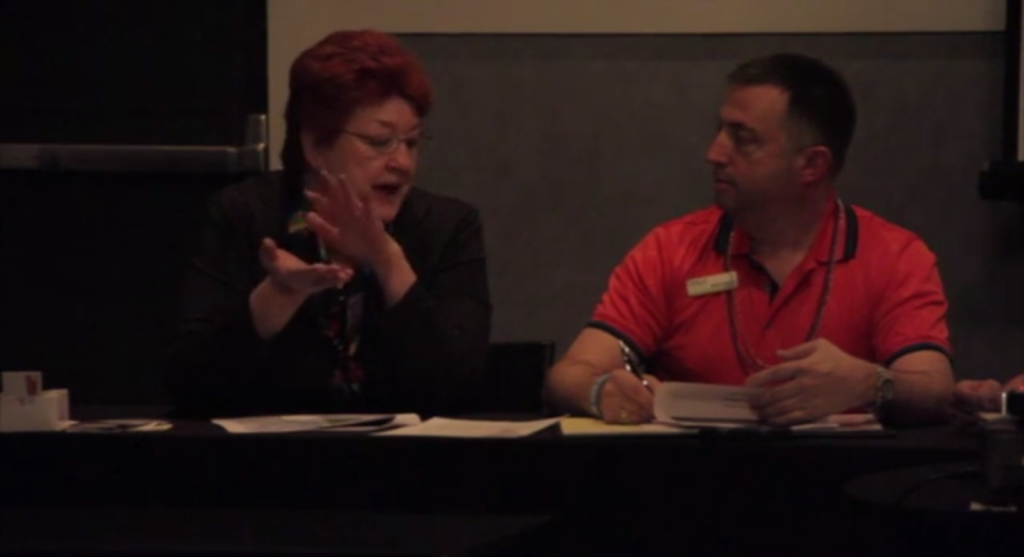 Two members speaking during a mock board meeting