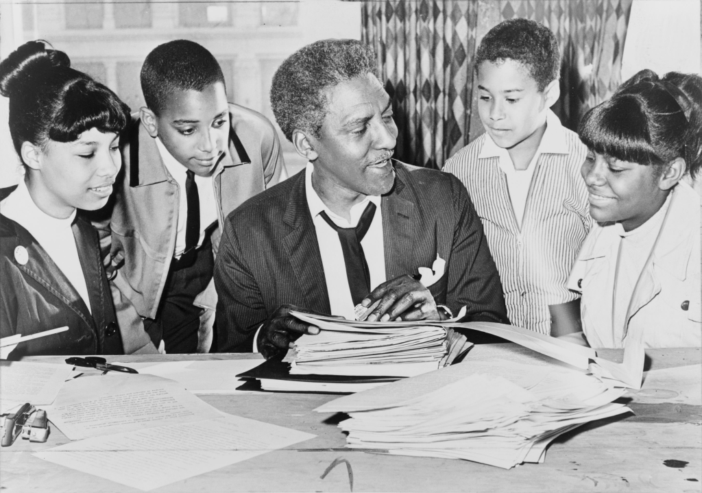 An activist discusses with a group of children