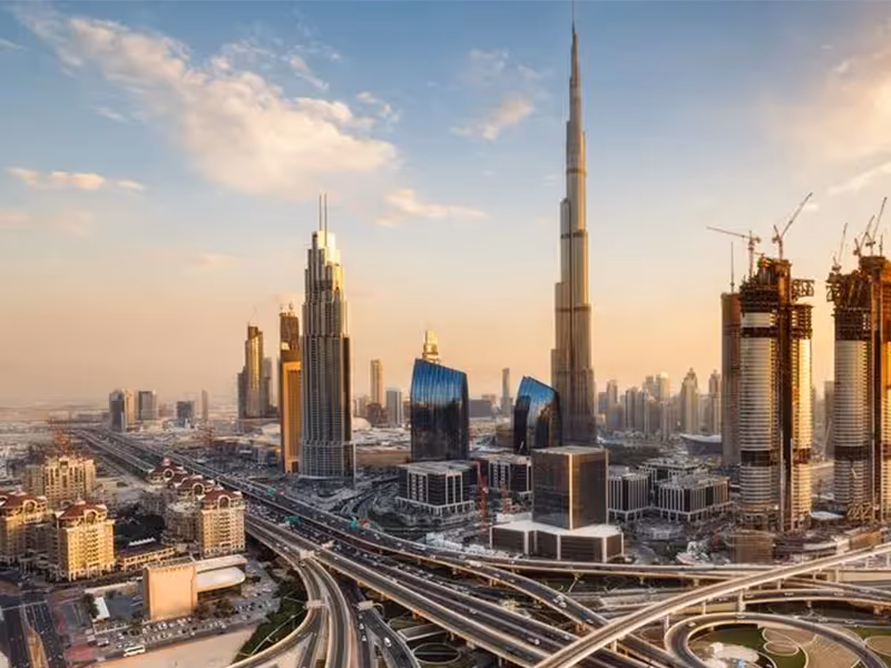 A sunset image of the Dubai skyline wit the Burj Khalifa