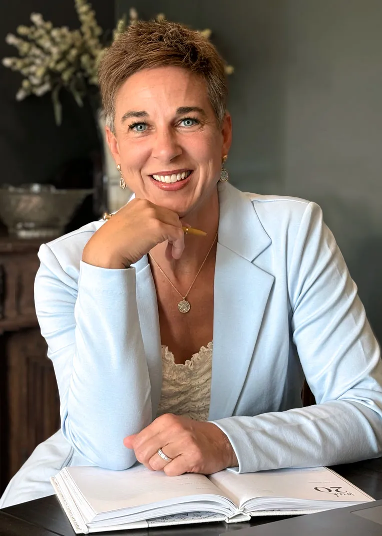 Dr Terri Fites smiling at camera while sitting at desk