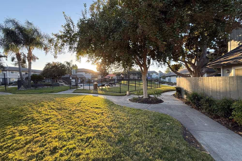 Exterior featuring walking path and view of swimming pool behind gate