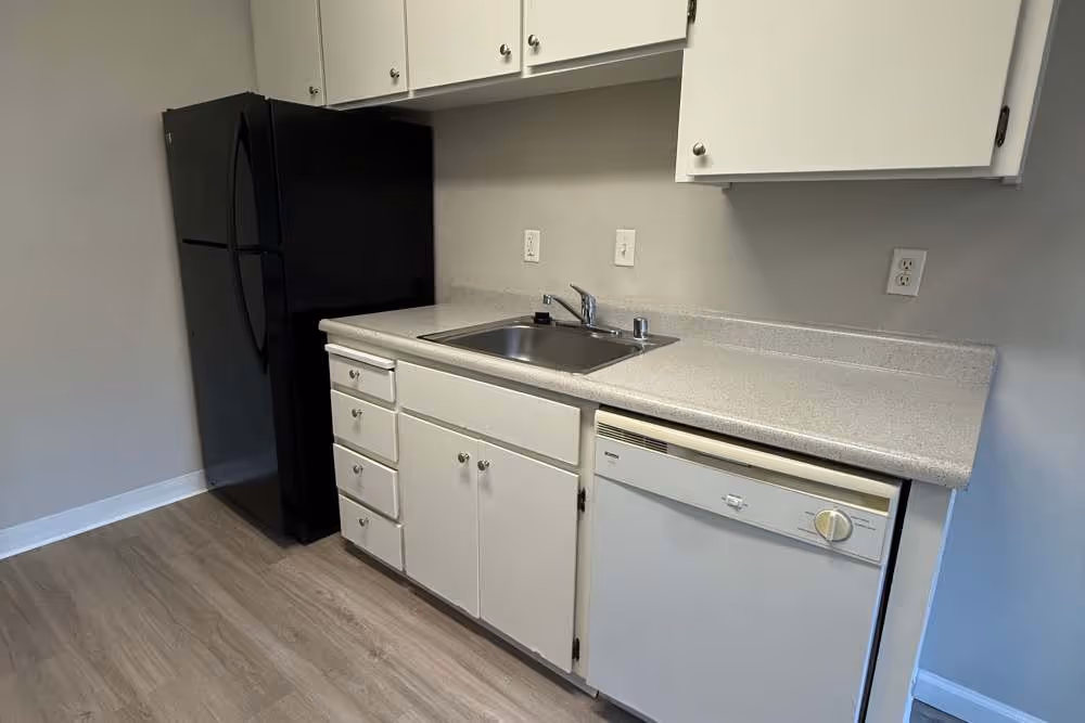 Kitchen with white cabinets and black appliances
