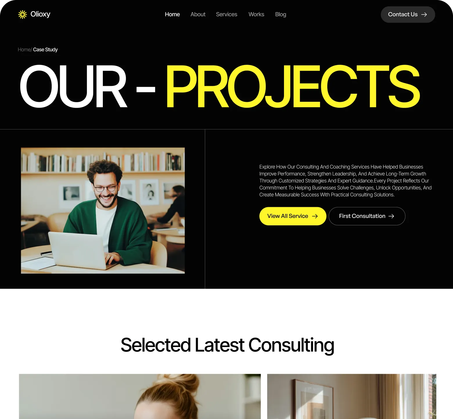 Website header with 'Our Projects' title, a man smiling while using a laptop, and buttons for viewing services and first consultation.