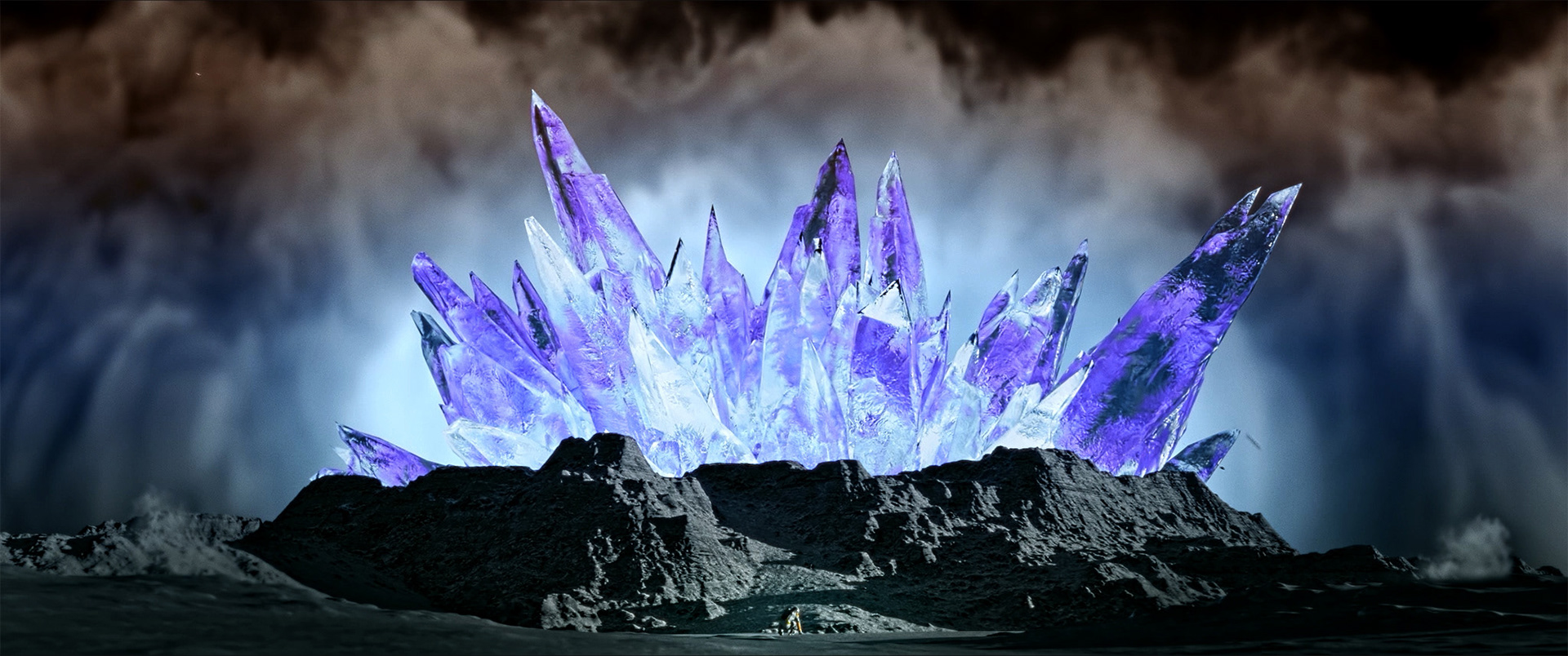 Large cluster of glowing purple crystals emerging from rocky dark ground under cloudy sky.