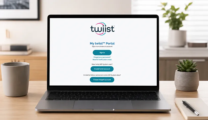 Laptop on desk displaying Twiist portal login with sign in and account creation options.