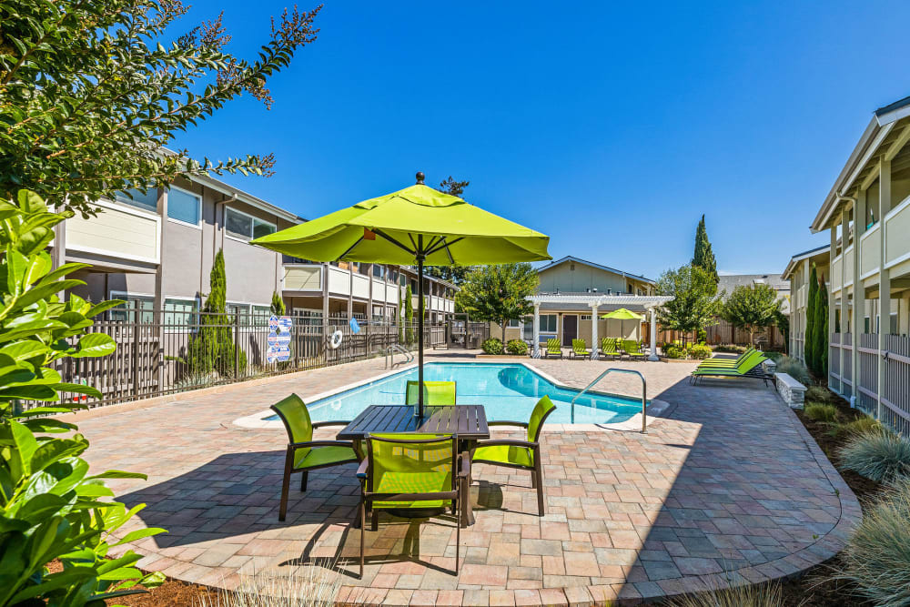 Table and chairs with umbrella near Swimming pool
