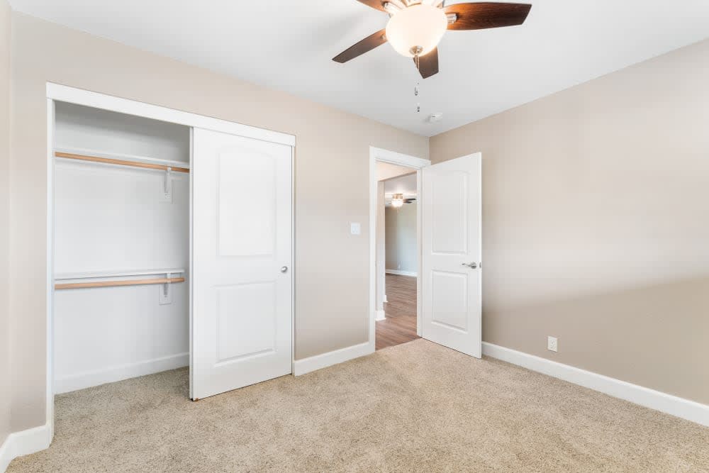 Unfurnished bedroom with carpet, closet and ceiling fan