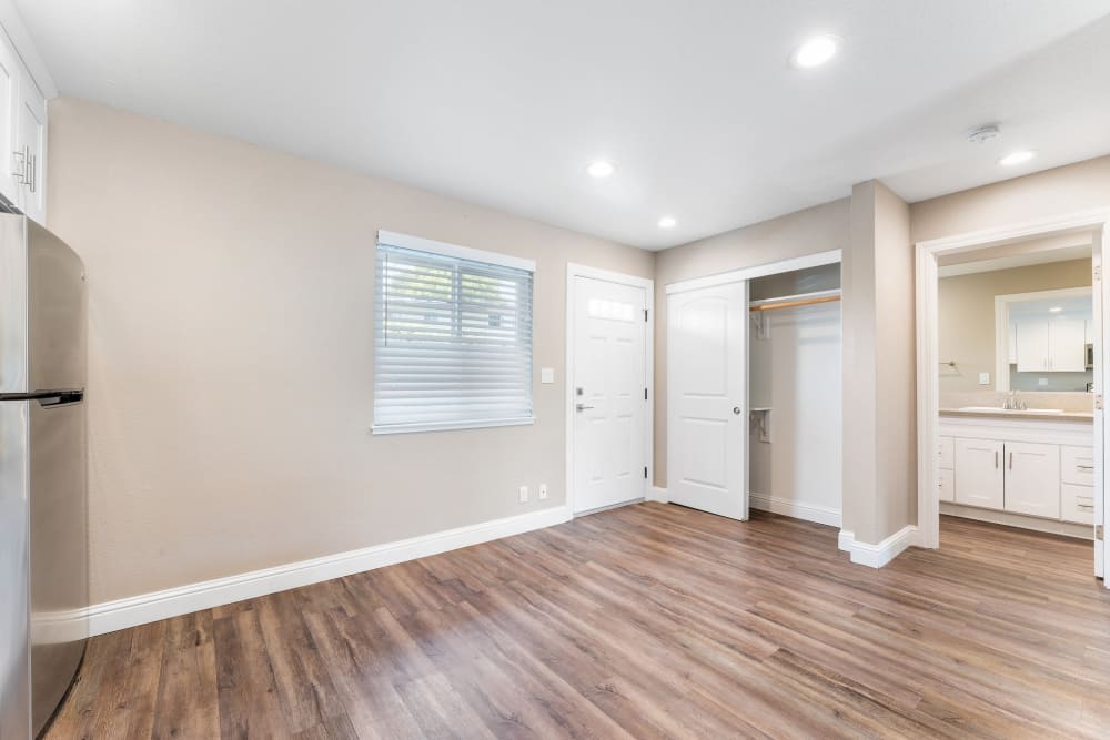 Unfurnished living and dining area with view of bathroom and linen closet