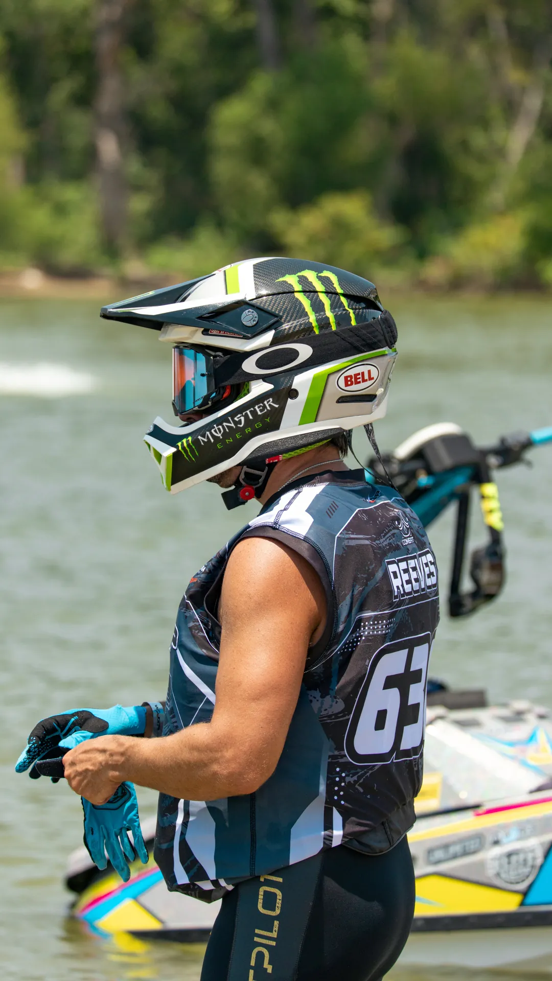Reeves #63 pulling on his gloves at the lake shore before a moto