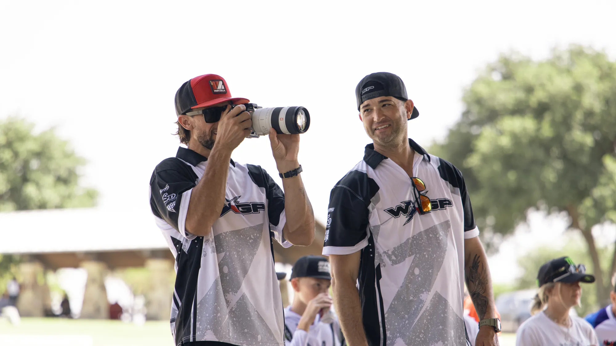 WXGP media crew in team shirts, one shooting on a telephoto lens