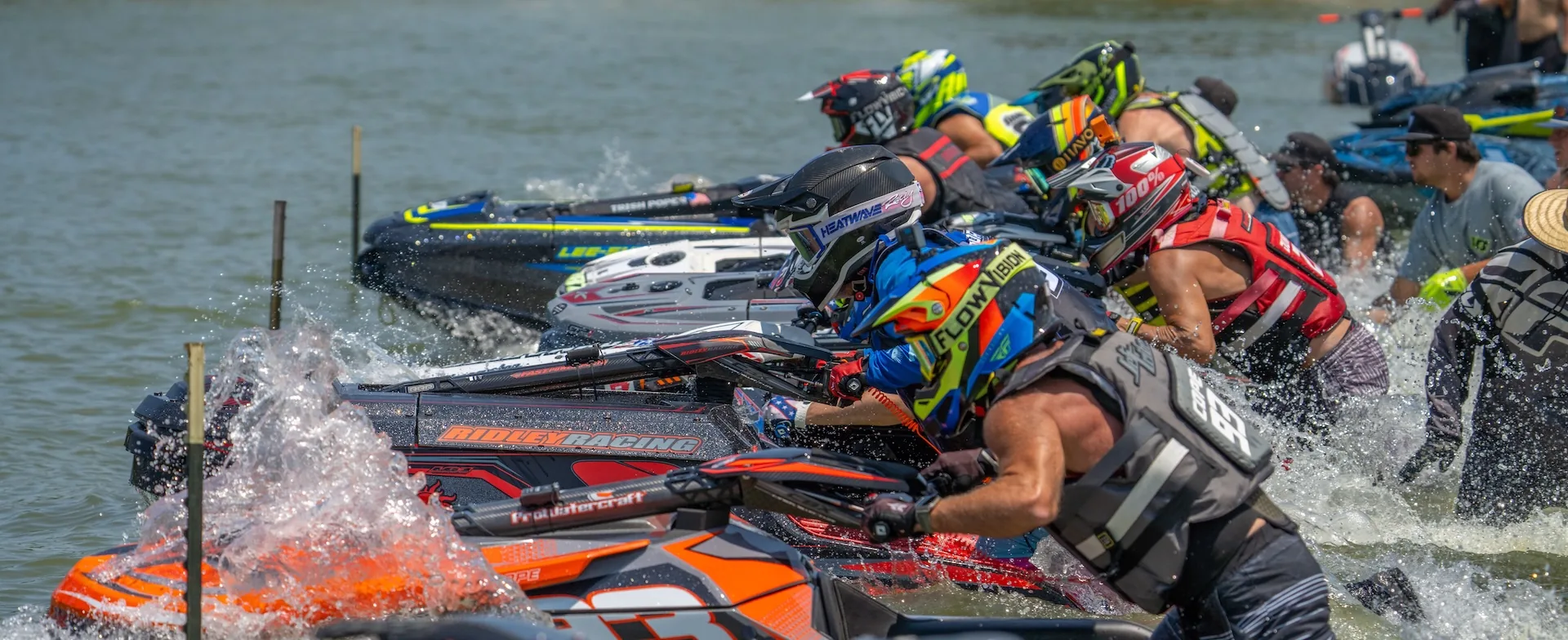 WXGP riders on the start line at the Beach Bash, holding their skis in the water