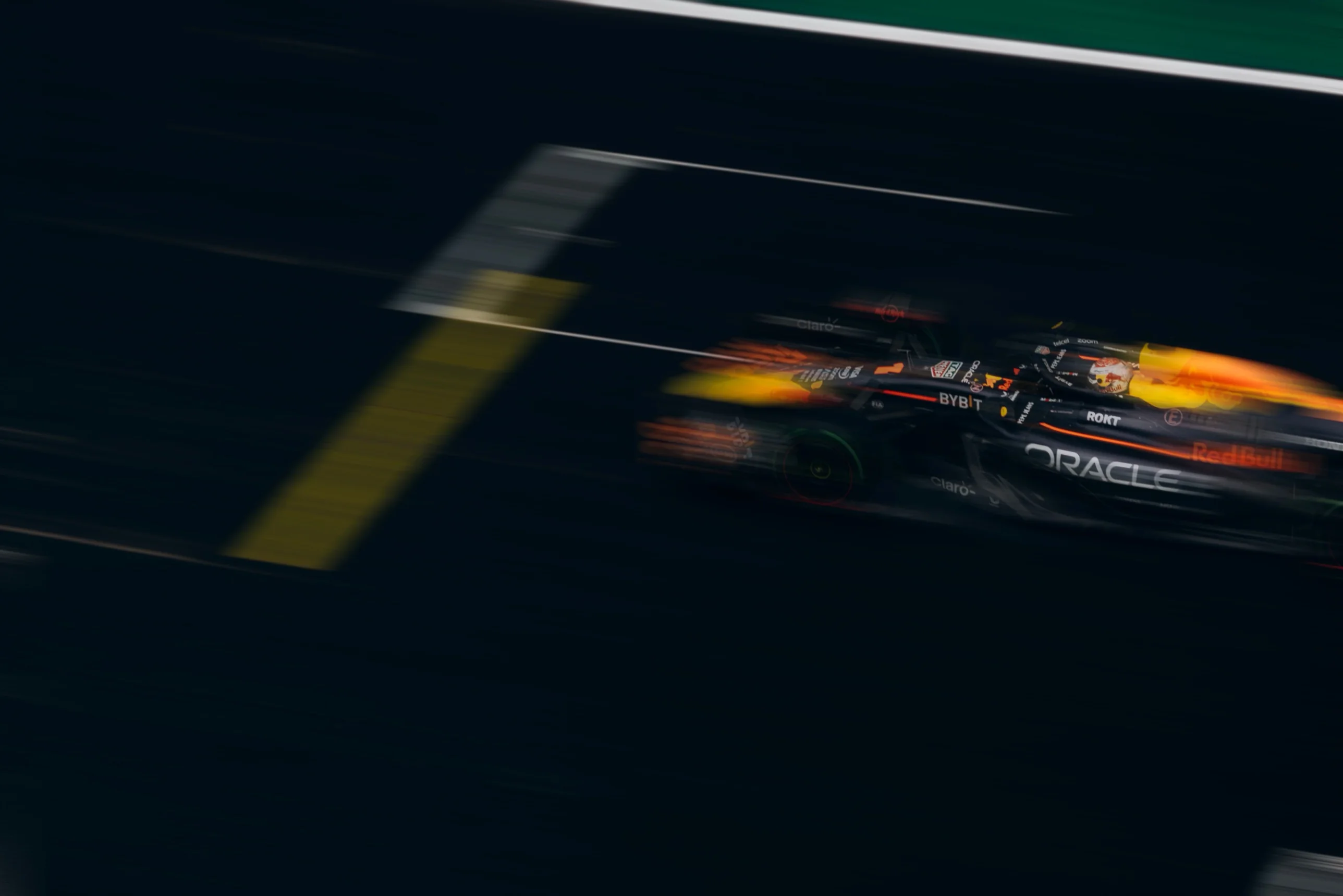 Formula 1 car blurred at speed past the pit lane line