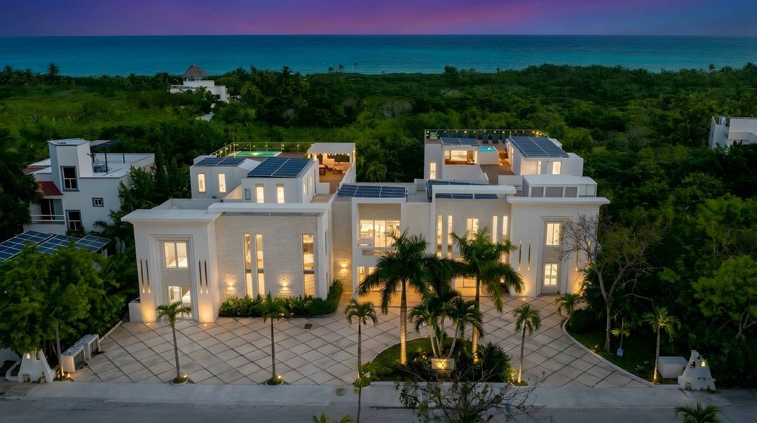 Top-down aerial of Villa Hurakán showing rooftop pools and tropical estate layout
