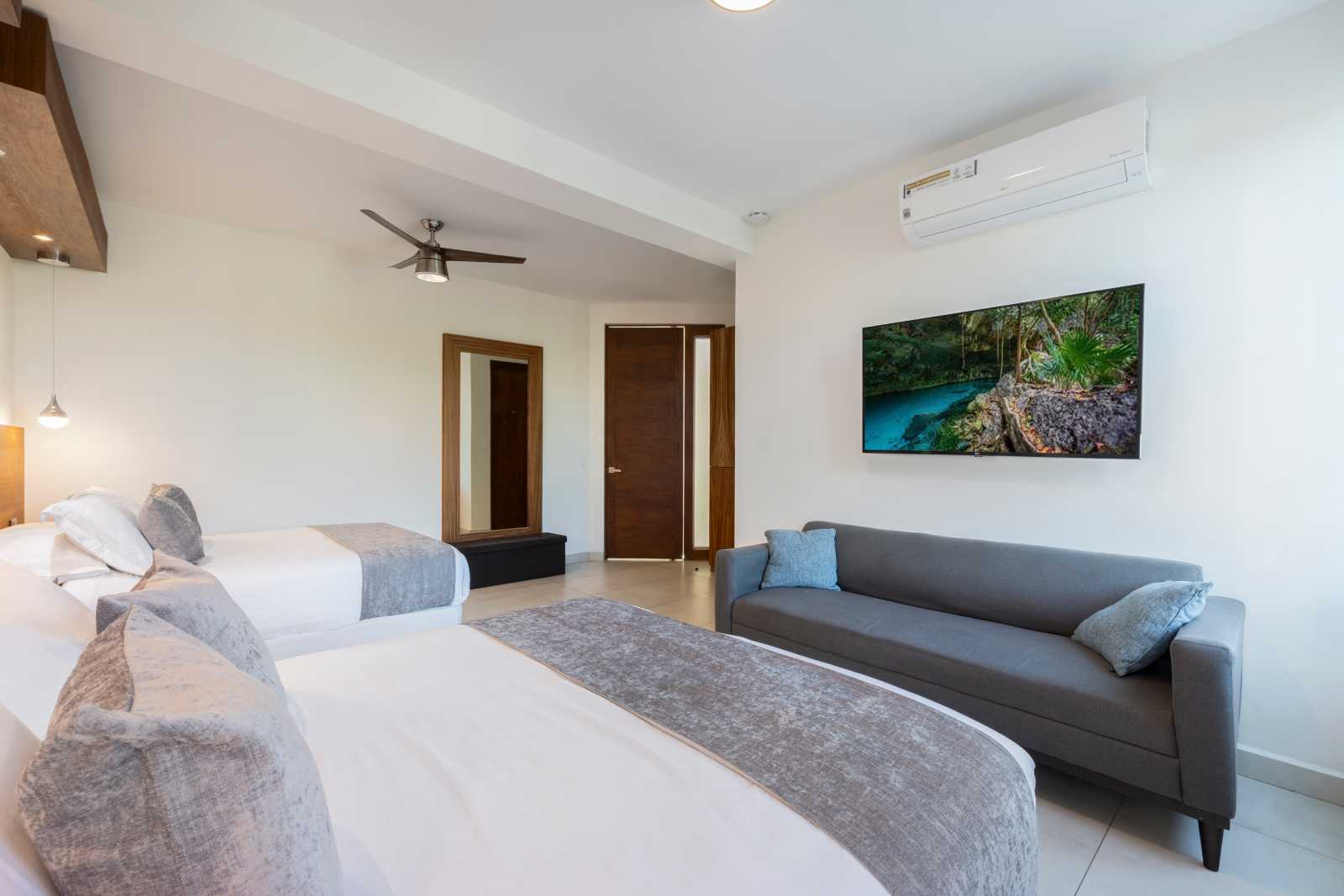 Spacious luxury bedroom with lounge seating inside Villa Hurakán