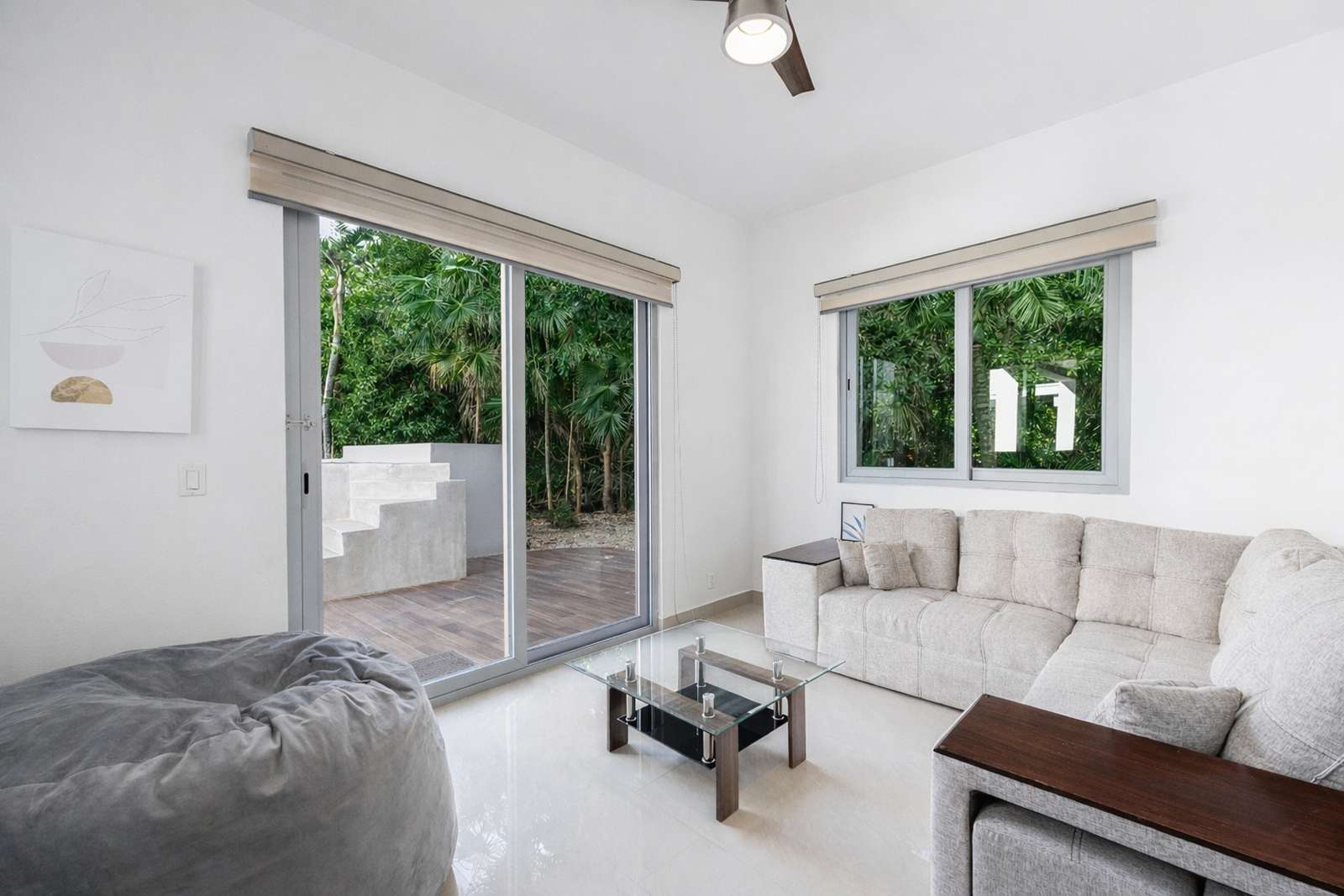 Modern bedroom lounge seating area inside Villa Hurakán luxury suite
