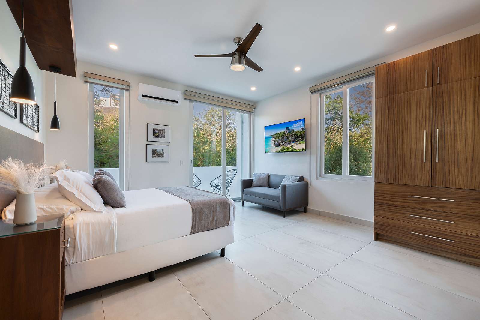 Luxury king bedroom with jungle-facing windows at Villa Hurakán